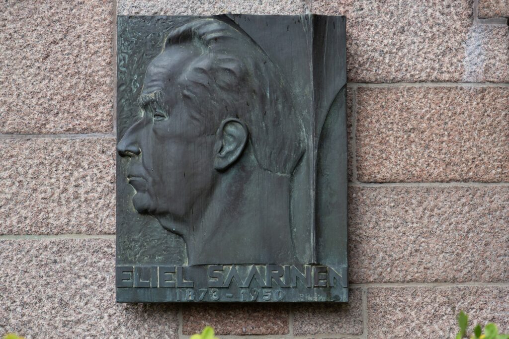 Bronze relief with a side profile of a man.