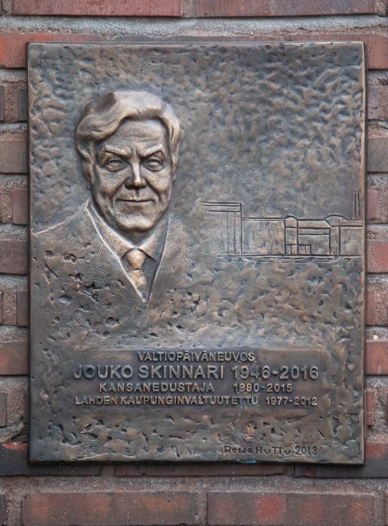 Relief of a bust of a smiling man.