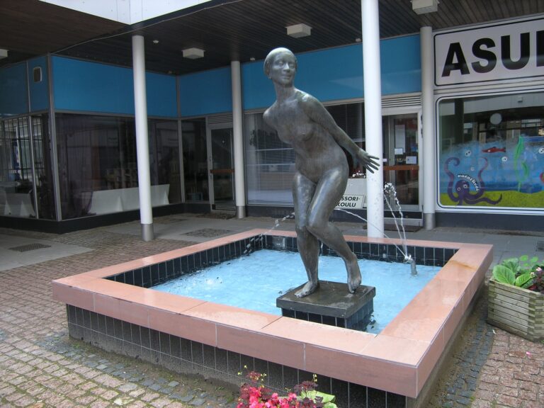 A fountain sculpture depicting a naked woman running away from the spray of water.