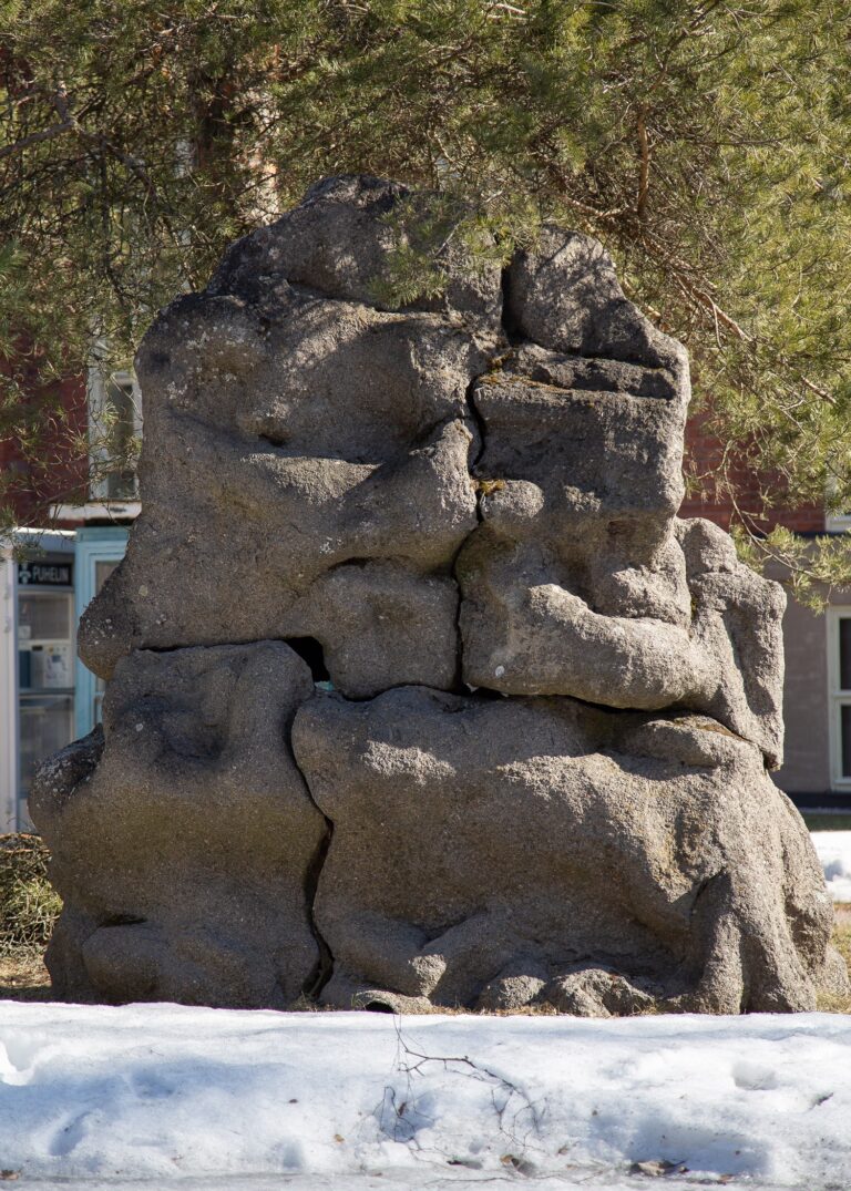 A concrete sculpture depicting intertwined human figures.