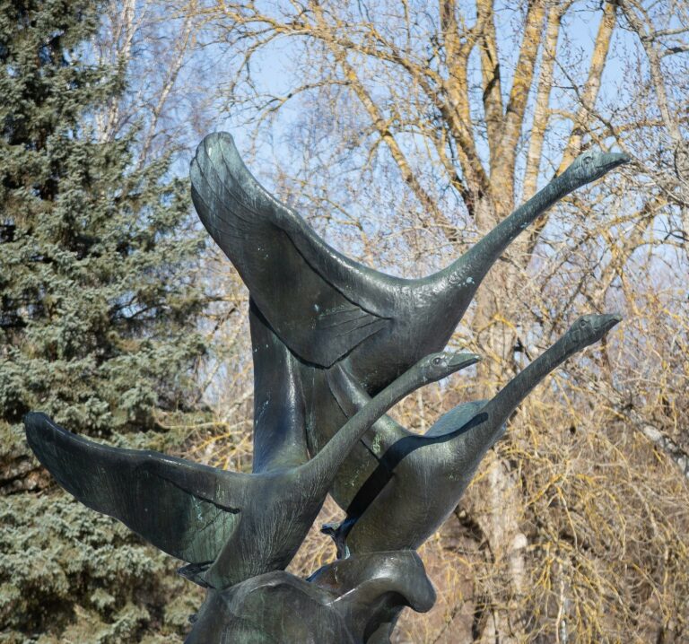 Bronze sculpture depicting three swans.