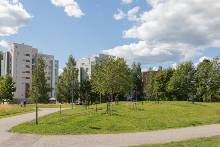 Park in front of apartment buildings.