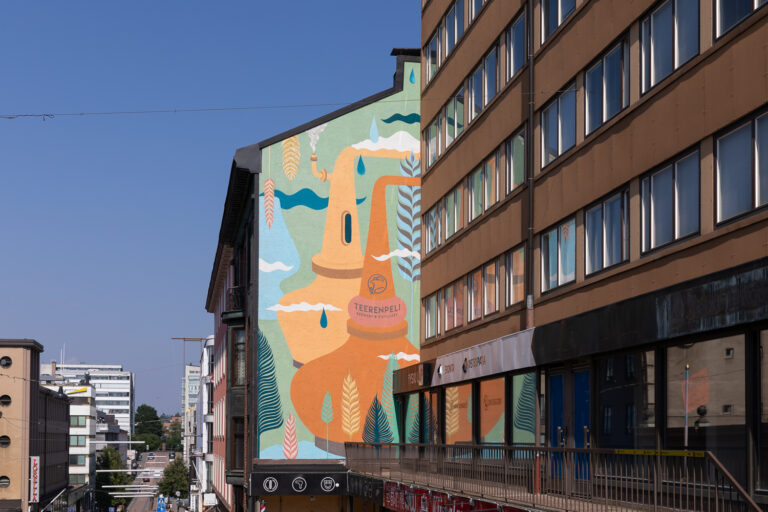 Street view of the side of a house with a colorful mural painted on it.