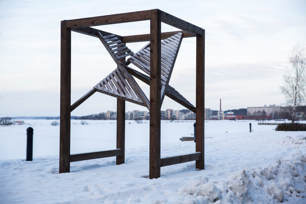 Wooden artwork in a winter landscape.