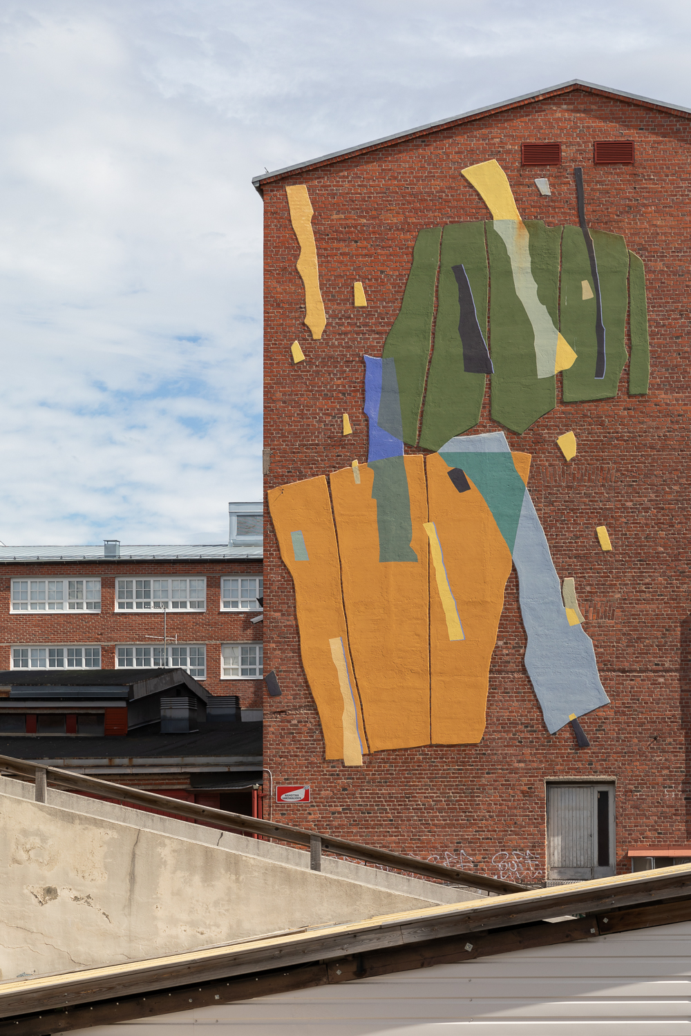 Colorful mural on a brick building's wal.