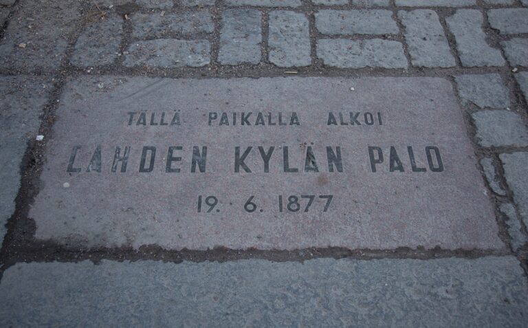 A memorial plaque embedded in the street paving.